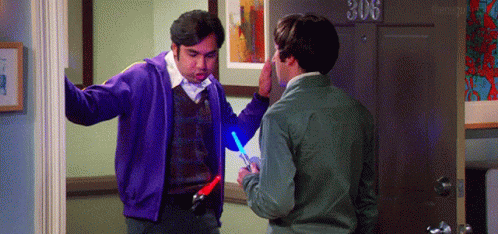 Man in Purple Jacket Holding Light Saber