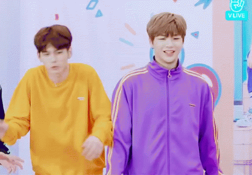 Man in Purple Jacket Next to Man in Yellow Sweatshirt