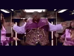 Man In Purple Jacket Standing With Arms Out GIF