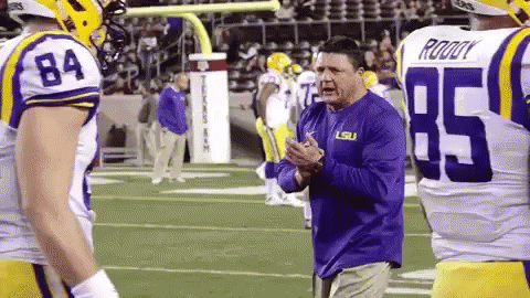Man in Purple LSU Shirt on Football Field