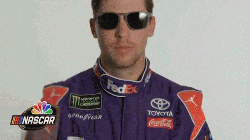 Man in Purple Race Suit and Sunglasses With NASCAR Logo