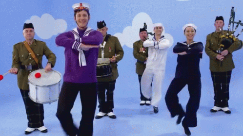 Man in Purple Sailor Uniform Dancing with Band
