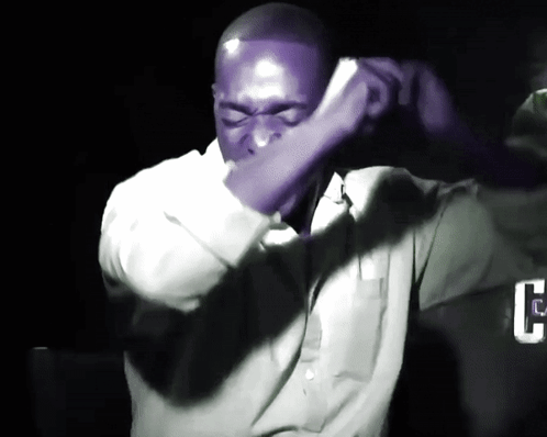 Man in Purple Shirt Covering Face