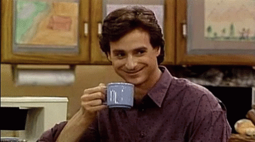 Man in Purple Shirt Drinking from Blue Mug