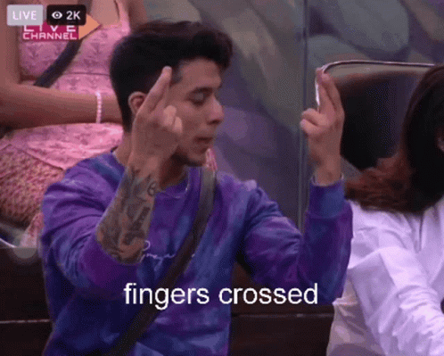 Man In Purple Shirt Giving Middle Finger Saying Fingers Crossed GIF