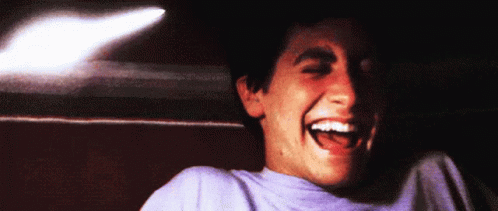 Man in Purple Shirt Laughing Mouth Wide Open