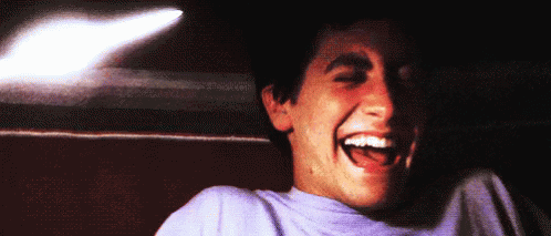 Man in Purple Shirt Laughing Open-Mouthed