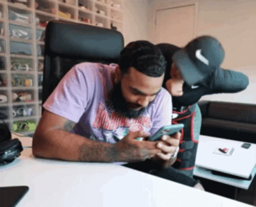 Man In Purple Shirt Looking At Cellphone GIF