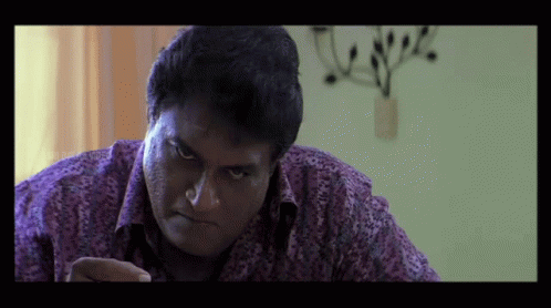 Man in Purple Shirt Looking at Something