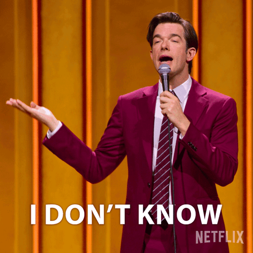 Man in Purple Suit Holding Microphone Saying I Don't Know
