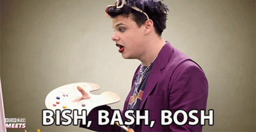 Man in Purple Suit Holding Palette Saying Bash Bash Bash