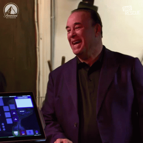 Man in Purple Suit Laughing in Front of Paramount Network Screen