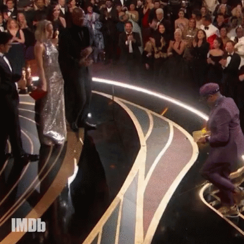 Man in Purple Suit on Stage with IMDB Crowd