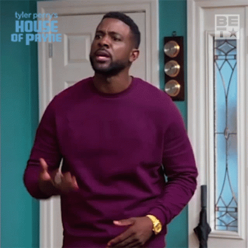 Man in Purple Sweater in Front of House of Payne Door