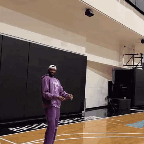 Man in Purple Sweatshirt on Brooklyn Nets Court
