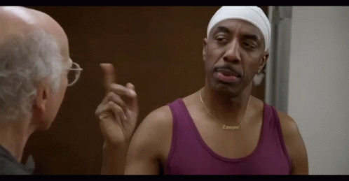 Man in Purple Tank Talking to Man with Glasses