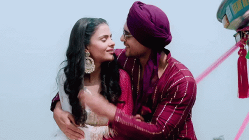 Man In Purple Turban Hugging Woman In Pink Dress GIF