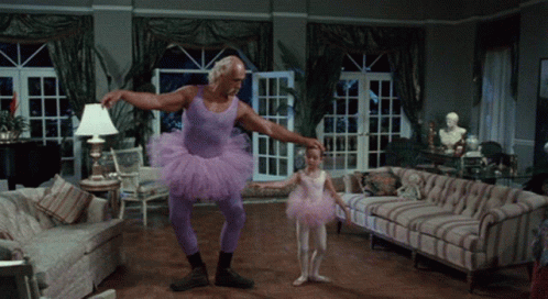 Man in Purple Tutu Holding Little Girl in Pink Tutu