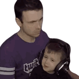 Man in Purple Twitch Shirt Holding Child