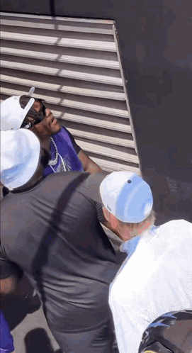 Man in Purple Vest and White Hat