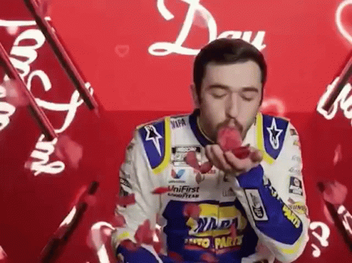 Man in Racing Suit Blowing Kiss