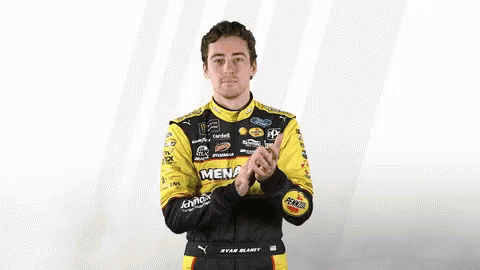 Man In Racing Suit Clapping GIF