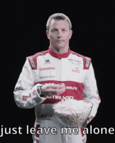 Man in Racing Suit Holding Popcorn