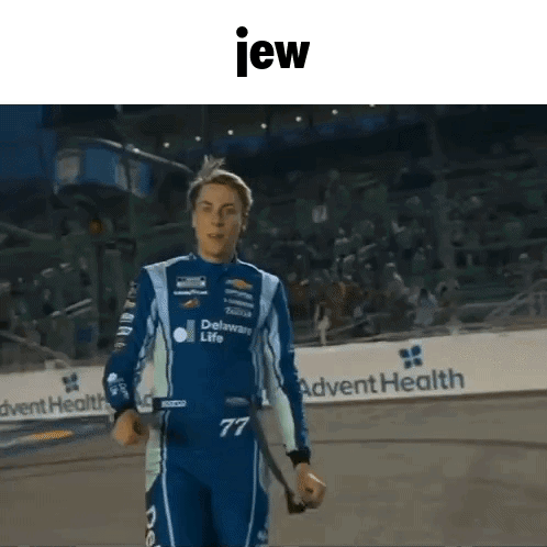 Man In Racing Suit Holding Stick GIF