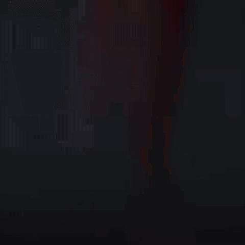 Man in Racing Suit Standing in Front of Car in Dark