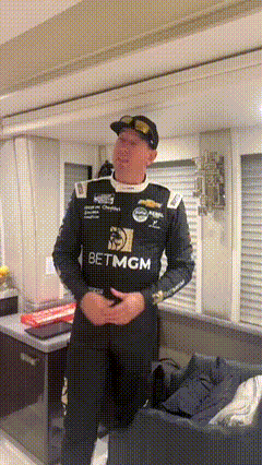 Man in Racing Uniform in Living Room