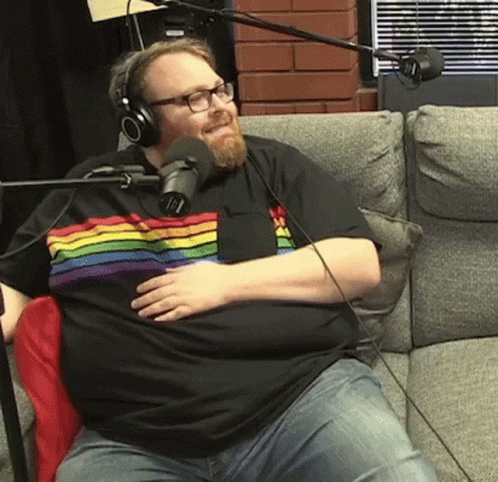 Man in Rainbow Shirt with Headphones at Microphone