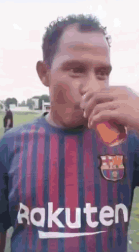 Man in Rakuten Jersey Drinking From Glass
