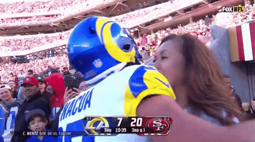 Man in Rams Jersey Kissing Woman