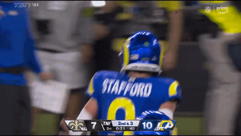 Man in Rams Jersey Stands on Field