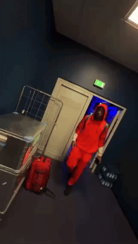 Man in Red Adidas Hoodie Talking to Another Man