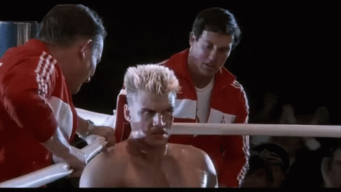 Man in Red Adidas Jacket and Boxer in Ring