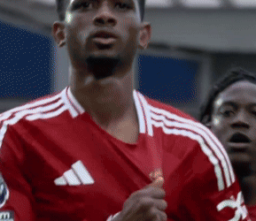 Man in Red Adidas Jersey Holding Medal