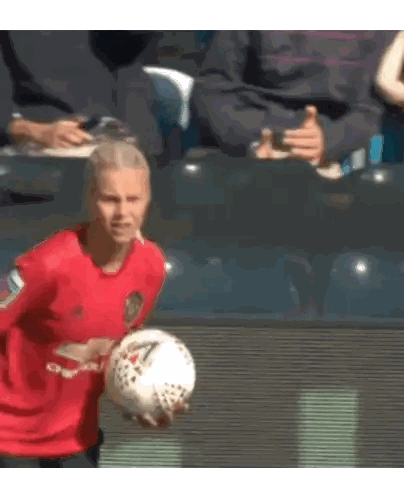 Man in Red Adidas Jersey Holding Soccer Ball