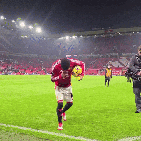 Man in Red Adidas Jersey Holding Soccer Ball