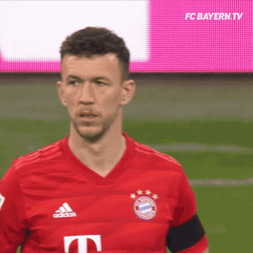 Man in Red Adidas Shirt on Field
