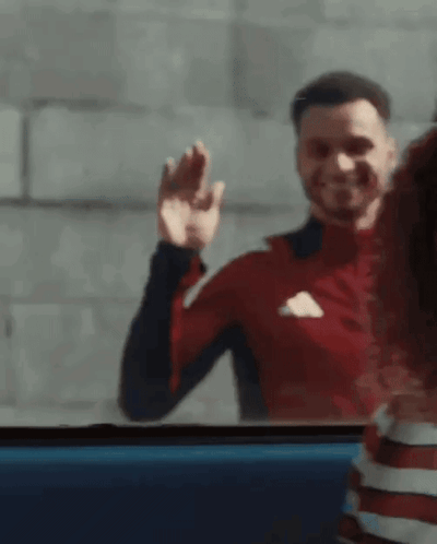 Man in Red Adidas Shirt Waving