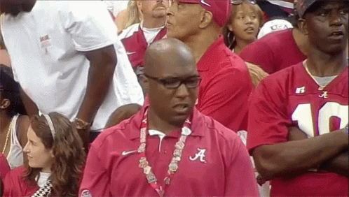 Man in Red Alabama Shirt Stands in Crowd