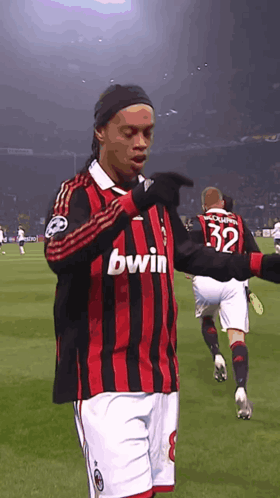 Man In Red And Black Bwin Jersey On Field GIF