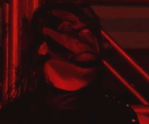 Man in Red and Black in Wrestling Ring with Pentagram