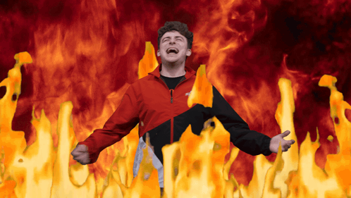 Man in Red and Black Jacket Surrounded by Fire