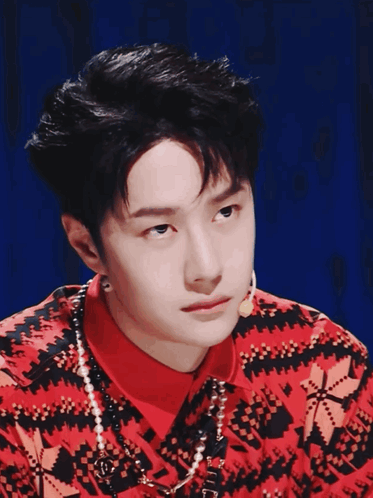 Man In Red And Black Sweater With Pearls GIF