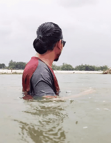 Man in Red and Grey Shirt in Water