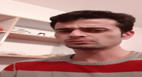 Man in Red and Grey Sweater Making Funny Face