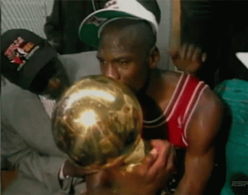 Man in Red and White Jersey Kissing Gold Trophy