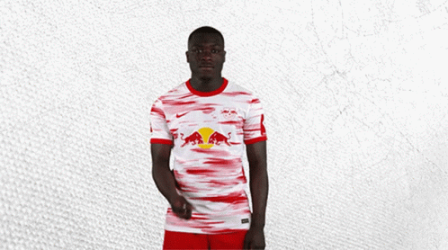 Man in Red and White Jersey With Bull